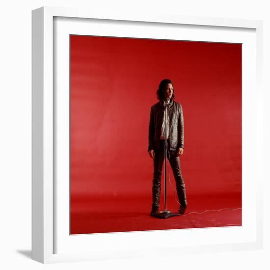 Rock Star Jim Morrison of the Doors Standing Behind Microphone Alone Against a Red Backdrop-Yale Joel-Framed Premium Photographic Print