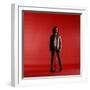 Rock Star Jim Morrison of the Doors Standing Behind Microphone Alone Against a Red Backdrop-Yale Joel-Framed Premium Photographic Print