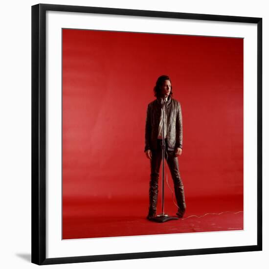 Rock Star Jim Morrison of the Doors Standing Behind Microphone Alone Against a Red Backdrop-Yale Joel-Framed Premium Photographic Print