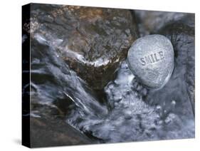 Rock with the Word Smile in Rushing Water-null-Stretched Canvas