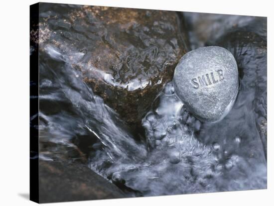 Rock with the Word Smile in Rushing Water-null-Stretched Canvas