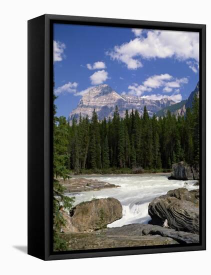 Rocks and Trees Beside a River with the Rocky Mountains in the Background, British Columbia, Canada-Harding Robert-Framed Stretched Canvas