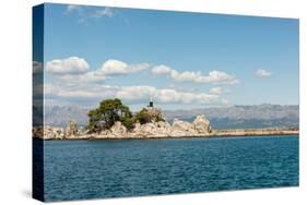 Rocks the Harbour Wall and a Statue of the Madonna in the Harbour at Trpanj Croatia-Julian Eales-Stretched Canvas