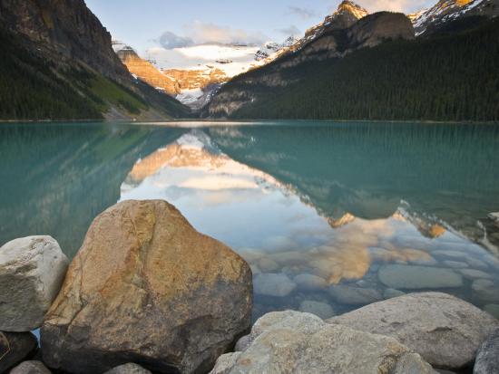 Rocky Mountains And Boulders Reflected In Lake Louise Banff National