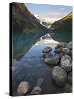 Rocky Mountains and Boulders Reflected in Lake Louise, Banff National Park, Alberta, Canada-Larry Ditto-Stretched Canvas