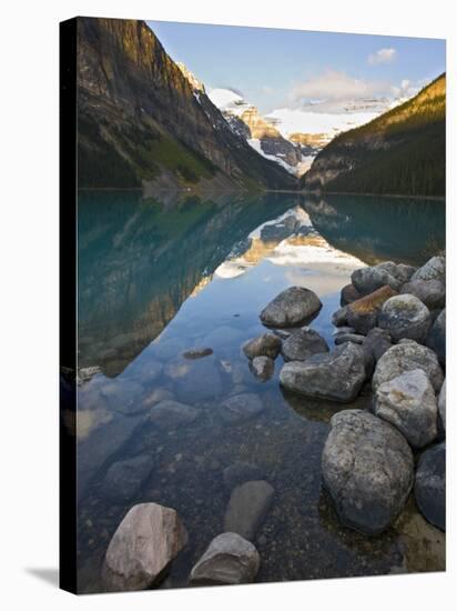 Rocky Mountains and Boulders Reflected in Lake Louise, Banff National Park, Alberta, Canada-Larry Ditto-Stretched Canvas