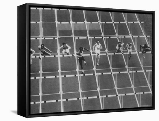 Rod Milburn Leading in the 110 Meter Hurdles at Summer Olympics-John Dominis-Framed Stretched Canvas