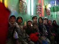 Afghan Boys Watch a Movie on a Television, Unseen, as They Eat Ice Cream at an Ice Cream Shop-Rodrigo Abd-Photographic Print