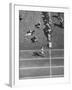 Roger Bannister Finishing a Race During the British Empire Games-null-Framed Premium Photographic Print