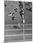 Roger Bannister Finishing a Race During the British Empire Games-null-Mounted Premium Photographic Print