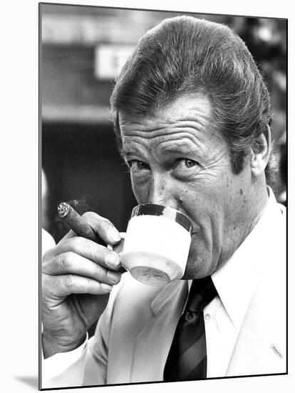 Roger Moore Drinking Coffee-Associated Newspapers-Mounted Photo