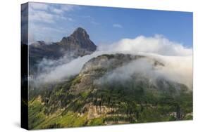 Rolling fog clouds with Heavy Runner and Reynold Mountains at Logan Pass in Glacier National Park-Chuck Haney-Stretched Canvas