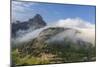 Rolling fog clouds with Heavy Runner and Reynold Mountains at Logan Pass in Glacier National Park-Chuck Haney-Mounted Photographic Print