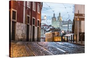 Romantic Atmosphere in Old Streets of Alfama with Castle in Background and Tram Number 28-Roberto Moiola-Stretched Canvas