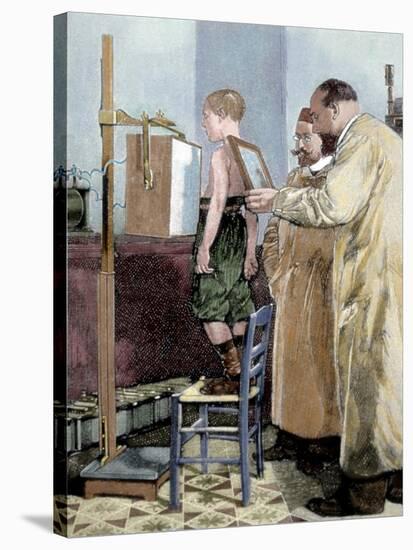 Rontgen, Wilhelm Conrad (1845-1923). German Physicist. Rontgen Exploring a Child with X-Ray Device-Tarker-Stretched Canvas