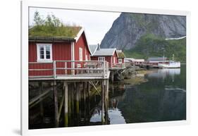 Rorbuer, traditional fishermnen's cottages now used for tourist accommodaton in Reine-Ellen Rooney-Framed Photographic Print