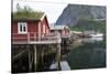 Rorbuer, traditional fishermnen's cottages now used for tourist accommodaton in Reine-Ellen Rooney-Stretched Canvas