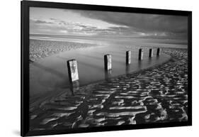 Rotting wooden posts of old sea defences on Winchelsea beach at low tide, Winchelsea, East Sussex-Stuart Black-Framed Photographic Print