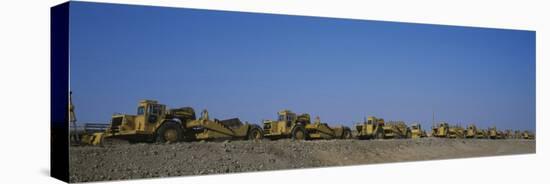 Row of Bulldozers at a Construction Site-null-Stretched Canvas