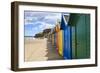 Row of Colourful Beach Huts and their Shadows, Distant Surfers in Sea, West Cliff Beach-Eleanor Scriven-Framed Photographic Print