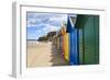 Row of Colourful Beach Huts and their Shadows, Distant Surfers in Sea, West Cliff Beach-Eleanor Scriven-Framed Photographic Print