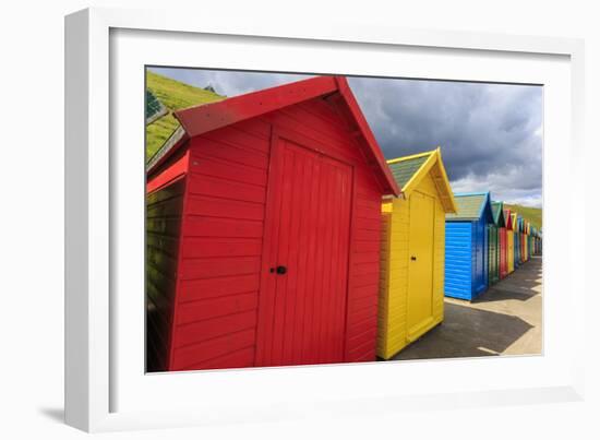 Row of Colourful Beach Huts and their Shadows, with Grassy Cliffs, West Cliff Beach-Eleanor Scriven-Framed Photographic Print