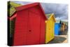 Row of Colourful Beach Huts and their Shadows, with Grassy Cliffs, West Cliff Beach-Eleanor Scriven-Stretched Canvas