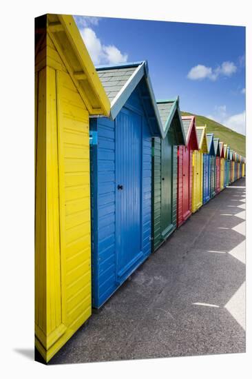 Row of Colourful Beach Huts and their Shadows with Green Hill Backdrop-Eleanor Scriven-Stretched Canvas