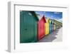 Row of Colourful Beach Huts and their Shadows with Green Hill Backdrop-Eleanor Scriven-Framed Photographic Print