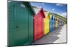 Row of Colourful Beach Huts and their Shadows with Green Hill Backdrop-Eleanor Scriven-Mounted Photographic Print