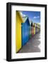 Row of Colourful Beach Huts and their Shadows with Green Hill Backdrop-Eleanor Scriven-Framed Photographic Print