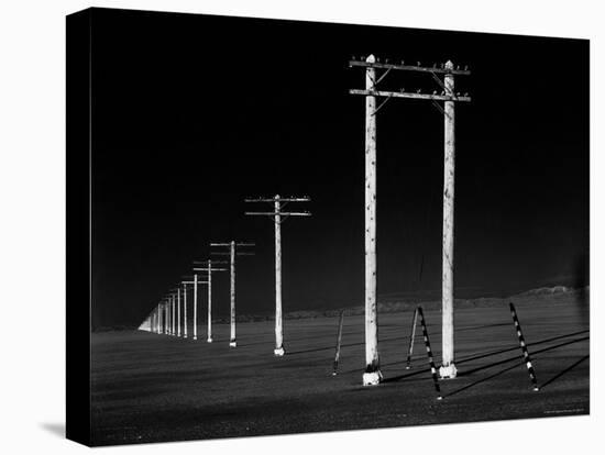 Row of Telephone Poles Along Bonneville Salt Flats-Fritz Goro-Stretched Canvas