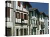 Row of Traditional Buildings in the Village of Ainhoa in the Pyrenees in Aquitaine, France-Michael Busselle-Stretched Canvas