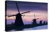 Row of Windmills at Sunrise in the Netherlands-Darrell Gulin-Stretched Canvas