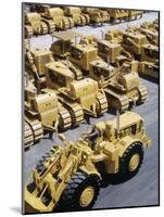 Rows of Brightly Colored Caterpillar Bulldozers Lined up at an Unidentified Factory-John Zimmerman-Mounted Photographic Print