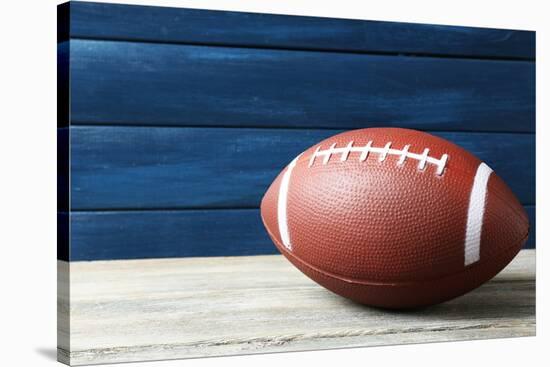 Rugby Ball on Wooden Background-Yastremska-Stretched Canvas