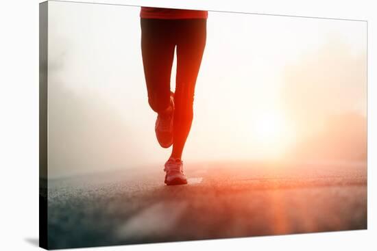 Runner Feet Running on Road Closeup on Shoe. Woman Fitness Sunrise Jog Workout Welness Concept.-warrengoldswain-Stretched Canvas