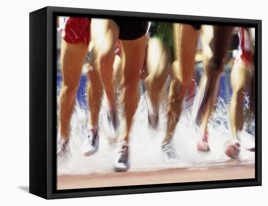 Runners Legs Splashing Through Water Jump of Track and Field Steeplechase Race, Sydney, Australia-Paul Sutton-Framed Stretched Canvas