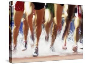 Runners Legs Splashing Through Water Jump of Track and Field Steeplechase Race, Sydney, Australia-Paul Sutton-Stretched Canvas