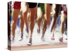 Runners Legs Splashing Through Water Jump of Track and Field Steeplechase Race, Sydney, Australia-Paul Sutton-Stretched Canvas