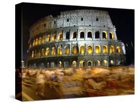 Runners Make Their Way Past the Colosseum in Rome-null-Stretched Canvas