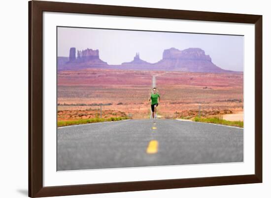 Running Man - Runner Sprinting on Road by Monument Valley. Concept with Sprinting Fast Training For-Maridav-Framed Photographic Print