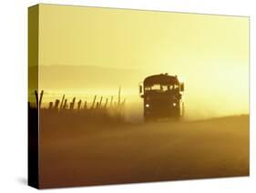 Rural School Bus Driving Along Dusty Country Road, Oregon, USA-William Sutton-Stretched Canvas