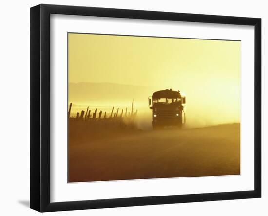 Rural School Bus Driving Along Dusty Country Road, Oregon, USA-William Sutton-Framed Photographic Print