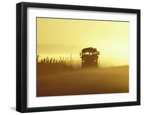 Rural School Bus Driving Along Dusty Country Road, Oregon, USA-William Sutton-Framed Photographic Print