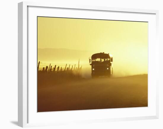 Rural School Bus Driving Along Dusty Country Road, Oregon, USA-William Sutton-Framed Photographic Print