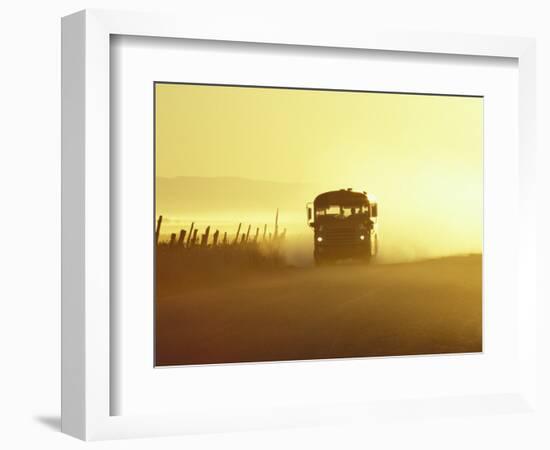 Rural School Bus Driving Along Dusty Country Road, Oregon, USA-William Sutton-Framed Photographic Print