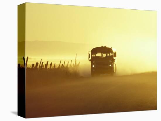 Rural School Bus Driving Along Dusty Country Road, Oregon, USA-William Sutton-Stretched Canvas