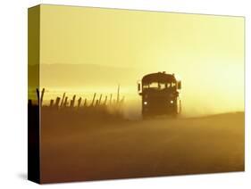 Rural School Bus Driving Along Dusty Country Road, Oregon, USA-William Sutton-Stretched Canvas