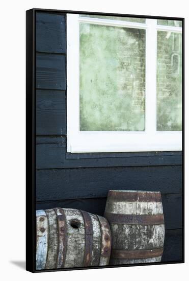 Rustic Barrels Lined Up Along an Old House Below a Window-Sheila Haddad-Framed Stretched Canvas